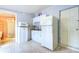 Small kitchenette with white cabinets, granite counters, and refrigerator at 6906 N Clark Ave, Tampa, FL 33614