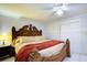 Spacious main bedroom with large wooden bed frame and ceiling fan at 6906 N Clark Ave, Tampa, FL 33614