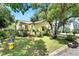 Yellow house with green lawn and mature trees at 810 E New Orleans Ave, Tampa, FL 33603