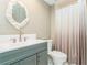 Bathroom with gray vanity, white toilet, and shower at 10823 Indian Hills Ct # 32, Seminole, FL 33777