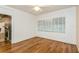 Light-filled bedroom featuring hardwood floors and a view of the fireplace at 10823 Indian Hills Ct # 32, Seminole, FL 33777