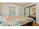 Bedroom with floral bedding, ceiling fan, and mirrored closet doors at 10823 Indian Hills Ct # 32, Seminole, FL 33777