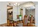 Glass-top dining table with four chairs in well-lit dining area at 10823 Indian Hills Ct # 32, Seminole, FL 33777