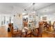 Elegant dining room with glass table and hardwood floors at 10823 Indian Hills Ct # 32, Seminole, FL 33777