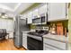 Modern kitchen featuring stainless steel appliances and granite countertops at 10823 Indian Hills Ct # 32, Seminole, FL 33777