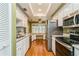 Kitchen features stainless steel appliances and white cabinets at 10823 Indian Hills Ct # 32, Seminole, FL 33777