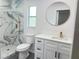 Updated bathroom with marble shower and modern vanity at 701 S Oakwood Ave, Brandon, FL 33511