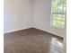 Simple bedroom with wood-look tile floor and large window at 701 S Oakwood Ave, Brandon, FL 33511