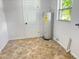 Laundry room with tile floors and a new water heater at 701 S Oakwood Ave, Brandon, FL 33511