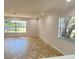 Bright living room featuring tile flooring and large windows at 701 S Oakwood Ave, Brandon, FL 33511