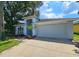 Gray exterior home with attached garage and landscaping at 2204 Cattleman Dr, Brandon, FL 33511