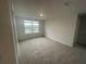 Bright bedroom with a large window and carpeting at 6303 Distant Haze Pl, Palmetto, FL 34221