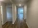 Bright and spacious hallway with wood-look flooring, leading to various rooms at 6327 Distant Haze Pl, Palmetto, FL 34221