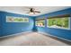 Bright bedroom with blue walls and large windows at 655 Appaloosa Rd, Tarpon Springs, FL 34688