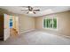 Spacious bedroom with carpeting, large window, and ceiling fan at 655 Appaloosa Rd, Tarpon Springs, FL 34688