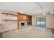 Gathering room with fireplace, built-ins, and sliding glass doors at 655 Appaloosa Rd, Tarpon Springs, FL 34688