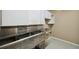 Kitchen featuring stainless steel sink and white cabinets at 655 Appaloosa Rd, Tarpon Springs, FL 34688