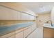 Laundry room with light blue countertops and cabinets at 655 Appaloosa Rd, Tarpon Springs, FL 34688