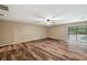 Spacious living room with wood-look flooring and sliding glass doors at 655 Appaloosa Rd, Tarpon Springs, FL 34688