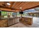 Outdoor kitchen with stone countertops and stainless steel appliances at 655 Appaloosa Rd, Tarpon Springs, FL 34688