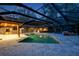 Night view of a large pool and spa under a covered patio at 655 Appaloosa Rd, Tarpon Springs, FL 34688