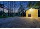 Well-lit yellow workshop at night with double doors and a basketball court nearby at 655 Appaloosa Rd, Tarpon Springs, FL 34688