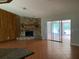 Living room with stone fireplace and sliding glass doors at 8602 Stoner Rd, Riverview, FL 33569