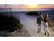 Couple walking on beach path at sunset at 2831 Jarvis Cir, Palm Harbor, FL 34683