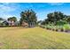 Landscaped community green space with mature trees and homes in the background at 320 Winterside Dr, Apollo Beach, FL 33572