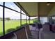 Spacious screened porch with golf course view and seating area at 10131 Old Tampa Bay Dr, San Antonio, FL 33576