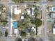 A neighborhood featuring a mix of single-story homes, mature trees, and a community swimming pool at 5824 11Th St, Zephyrhills, FL 33542