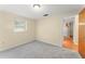 Bedroom featuring neutral walls, carpet and a window that allows natural light inside at 5824 11Th St, Zephyrhills, FL 33542