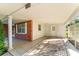 Covered carport featuring brick accent wall and white pillars, door on left goes into house at 5824 11Th St, Zephyrhills, FL 33542