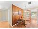 Dining area featuring a chandelier, wood paneled walls, and view into adjacent room at 5824 11Th St, Zephyrhills, FL 33542