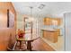 Dining area featuring a chandelier, wood paneled walls, and view into adjacent kitchen at 5824 11Th St, Zephyrhills, FL 33542