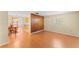 Open living room with wood wall feature, laminate floors, and view into dining area at 5824 11Th St, Zephyrhills, FL 33542
