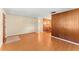 Open living room with wood wall feature, laminate floors, and view into dining area at 5824 11Th St, Zephyrhills, FL 33542