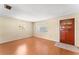 Bright living room with laminate floors, neutral walls, and two windows at 5824 11Th St, Zephyrhills, FL 33542