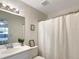 Clean bathroom with white vanity, shower, and decorative shower curtain at 1529 Highland Ridge Cir # 1529, Brandon, FL 33510