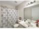 Clean bathroom with white vanity, shower, and patterned shower curtain at 1529 Highland Ridge Cir # 1529, Brandon, FL 33510