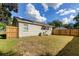 Large backyard with wooden fence and grassy area at 2409 S 70Th St, Tampa, FL 33619