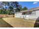 Backyard view showing home exterior, fence, and lawn at 2409 S 70Th St, Tampa, FL 33619