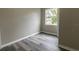 Simple bedroom with wood-look floors and a window at 2409 S 70Th St, Tampa, FL 33619