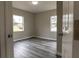 Bright bedroom with wood-look vinyl flooring and two windows at 2409 S 70Th St, Tampa, FL 33619