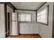 Small kitchen with stainless steel refrigerator and white cabinets at 2409 S 70Th St, Tampa, FL 33619