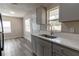 Modern kitchen featuring gray cabinets, white countertops, and stainless steel sink at 2409 S 70Th St, Tampa, FL 33619