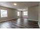 Spacious living room with wood-look floors and multiple windows at 2409 S 70Th St, Tampa, FL 33619