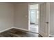 Living room with wood-look floors and an open doorway to an entryway at 2409 S 70Th St, Tampa, FL 33619