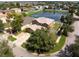 Aerial view of a brown home with a large pond and neighborhood in the background at 423 Chimney Rock Dr, Ruskin, FL 33570