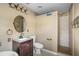 Bathroom featuring a dark vanity, toilet, and tiled walk-in shower at 423 Chimney Rock Dr, Ruskin, FL 33570